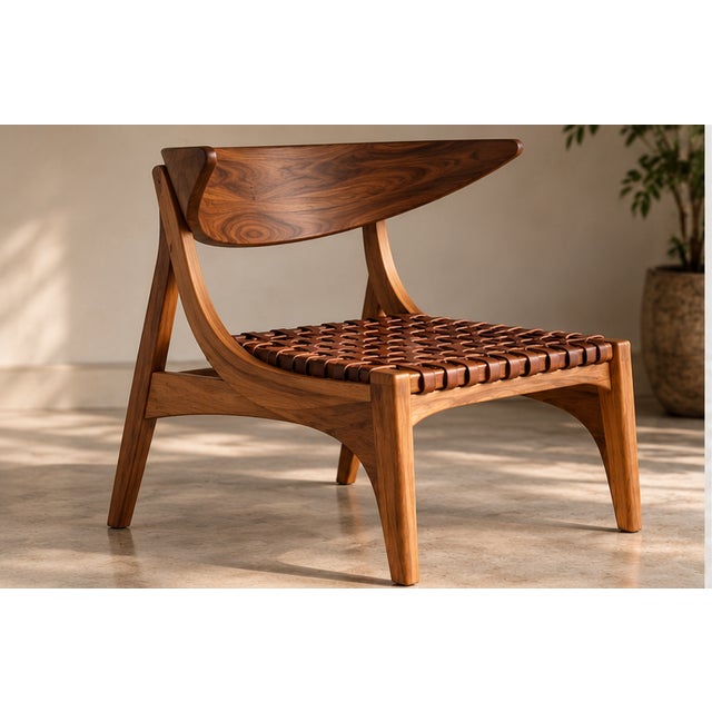 Klismos-Inspired Sculptural Lounge Chair A timeless fusion of classical Greek elegance and mid-century modern...