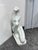 Design Plus Gallery presents a Signed Marble Art Deco Sculpture of a Kneeling Woman. The figure tilts her head upward with...
