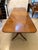 A substantial antique figured mahogany three-pillar extending dining table of classic rectangular form with softly rounded...