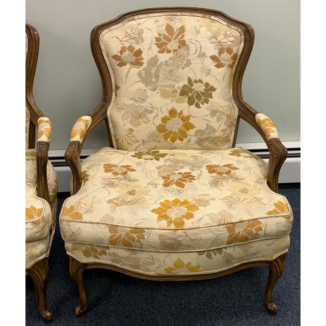Elevate your space with this beautiful pair of vintage French Louis XV-style bergère armchairs. Featuring elegant carved...