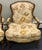 Elevate your space with this beautiful pair of vintage French Louis XV-style bergère armchairs. Featuring elegant carved...