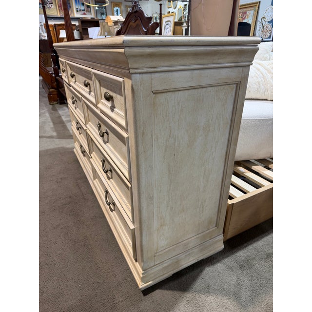 Elevate your bedroom with the timeless sophistication of this Bernhardt light wood nine-drawer dresser, a beautifully...