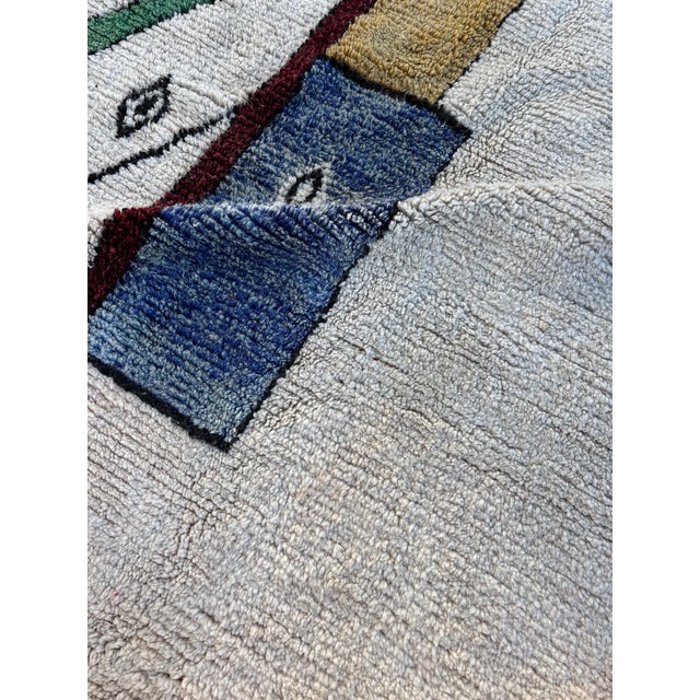 This large Moroccan Boujad rug is an authentic handwoven piece originating from the Middle Atlas region of Morocco,...