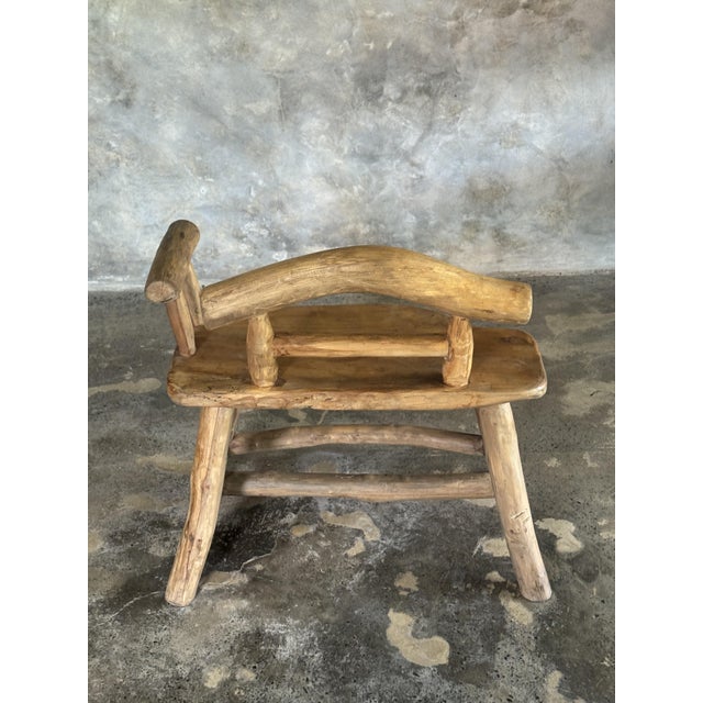 Small brutalist-style bench with backrest and armrests in light Asian teak. Dimensions: Width: 65cm; Total height: 67cm;...