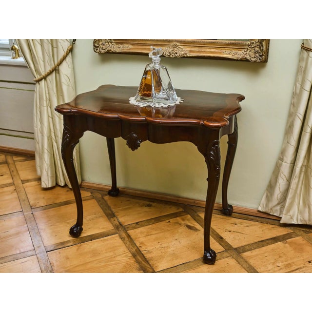 A smaller Chippendale style coffee table from the first half of the 20th century, circa 1920, made in England. The table...
