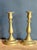Pair of cast brass candlesticks, each with an urn-form socket and wide dished drip pan on a knopped baluster stem, rising...