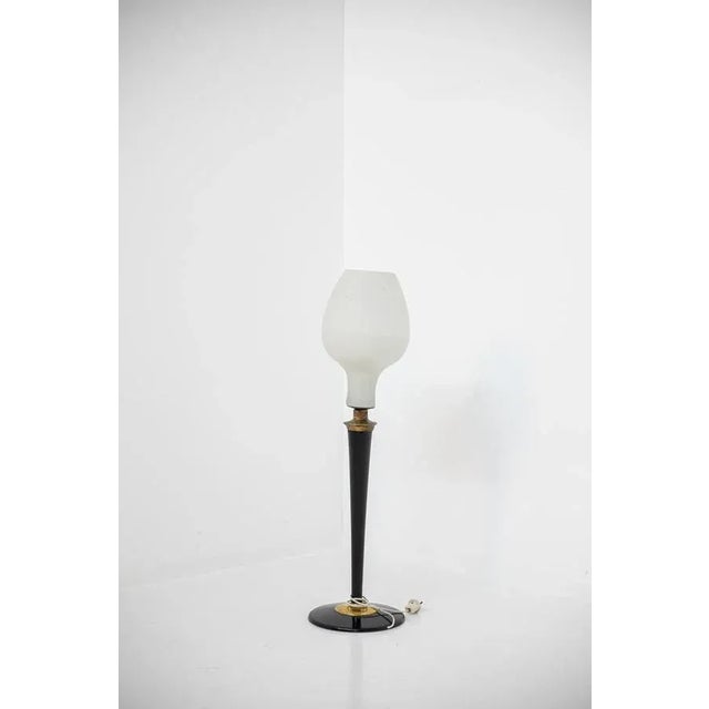 Large Italian table lamp from the 1950s. The lamp has an oval shaped opal glass light cover with a single central light....