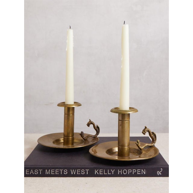 A striking pair of dragon handled chambersticks by Bradley and Hubbard, a Connecticut based company that what known for...