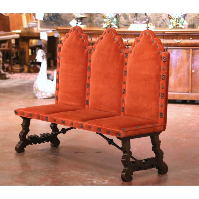 Architectural in form and richly detailed, this antique three-seat bench reflects the bold character of Spanish...