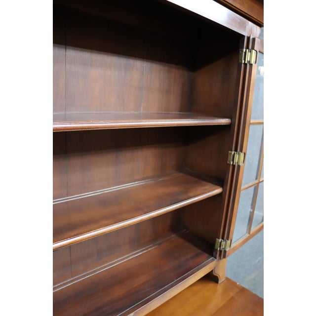 Statton step back cupboard in mahogany with upper glass display and lower storage cabinet. Top section features two wavy...