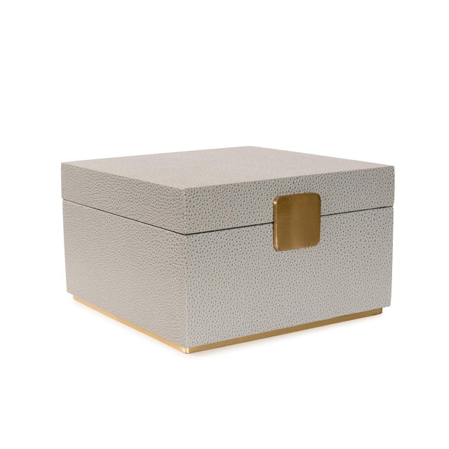 Sophisticated and functional, these decorative boxes feature a refined faux shagreen finish accented with warm gold...