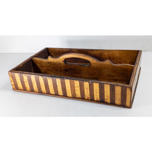 We are selling this very pretty banded marquetry tray. This sewing or letter tray, or knife tray, has dark and paler wood...