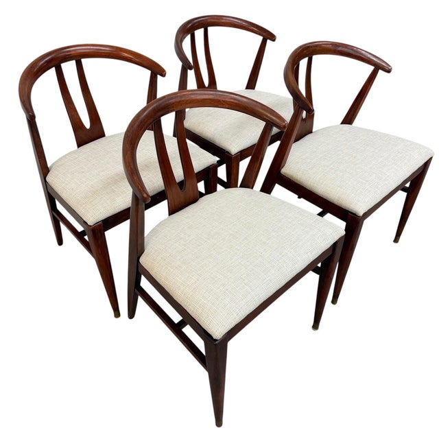 Elevate your dining space with this stylish set of four Mid-Century Modern wishbone-style dining chairs. Crafted with...