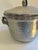This hammered aluminum lidded container features a tulip-shaped finial and applied Art Nouveau floral handle detailing,...