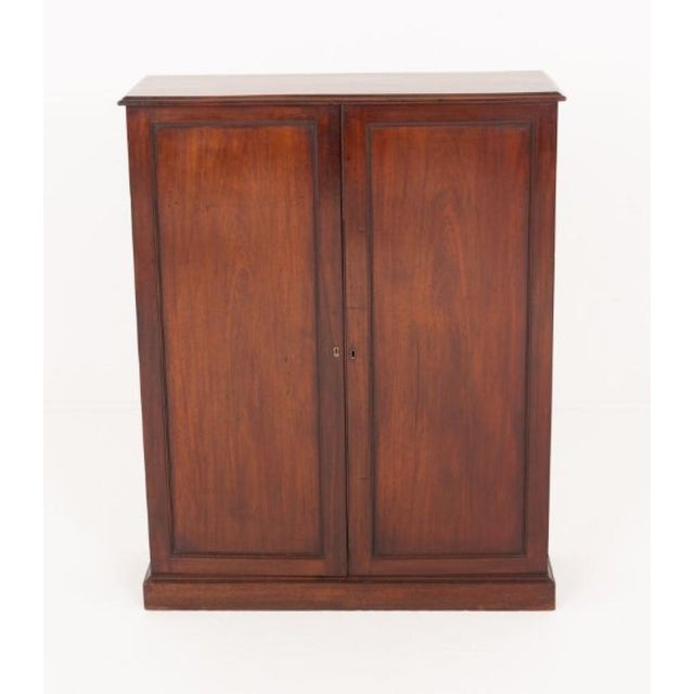 This elegant Victorian side cabinet is crafted from rich mahogany and stands on a sturdy plinth base Circa 1850 so period...