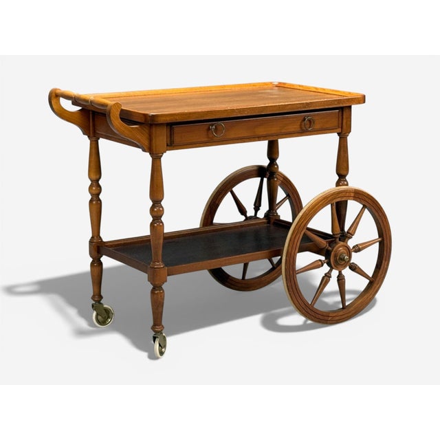 Swedish Mid-Century Modern, Rolling Bar Cart, Wood, Brass, Sweden, 1970s A large wood and brass rolling trolley designed...