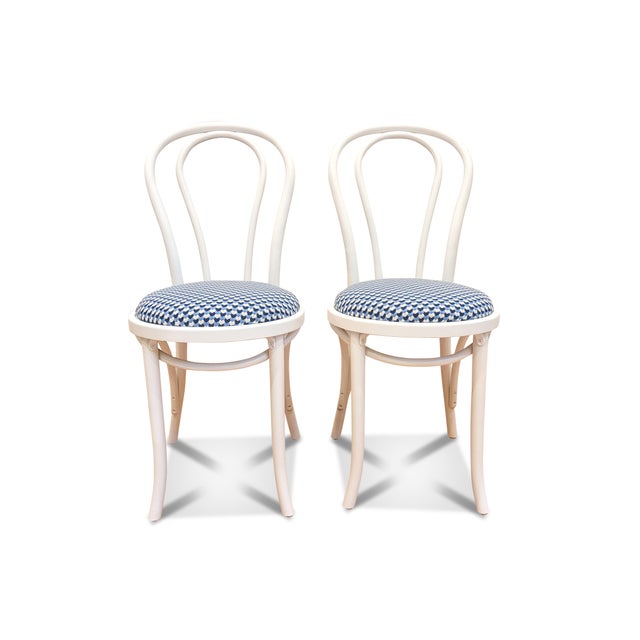 A pair of white bentwood cafe chairs that have been fully restored. The bistro chair pair have been painted white (semi-...