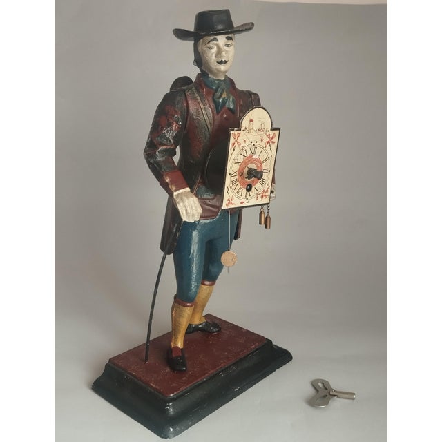 Rare JVE Germania clock, Black Forest, 1950s. Male figure in traditional costume (wanderer/citizen, 18th century) with...