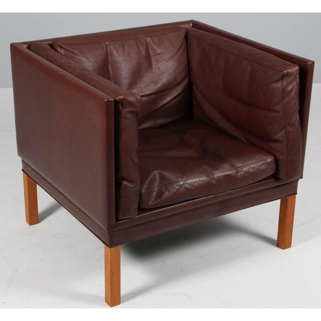 Illum Wikkelsø 1919-1999. Lounge chair, freestanding, upholstered in brown leather, loose cushions with down filling, oak...