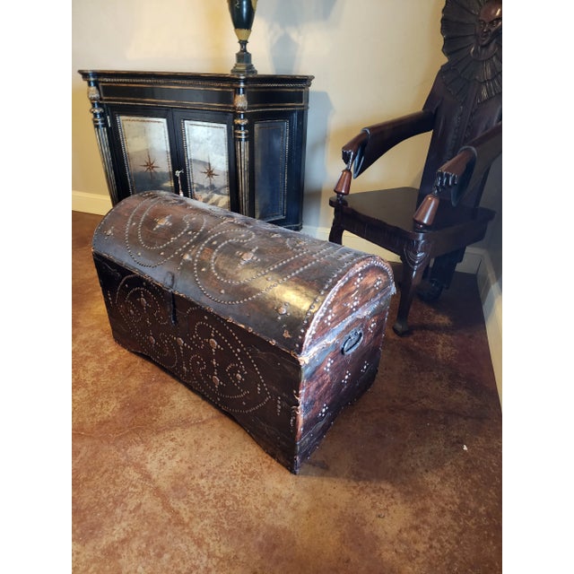 Wonderful antique leather over wood domed trunk. Great details with brass tac design details and old iron hardware.