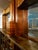 Beautifully restored antique circa 1940 Art Deco style wood and glass bar with decorative, multi-tonal veneer and inlay...