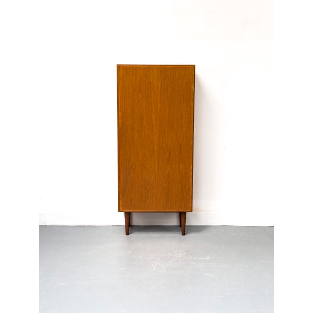 Minimalist cabinet with one door and three adjustable shelves This exclusive Danish piece of furniture was manufactured by...