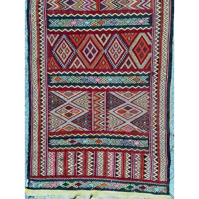 Beautiful colorful long Moroccan Kilim with nice tribal geometric design and beautiful colors, entirely handwoven with...