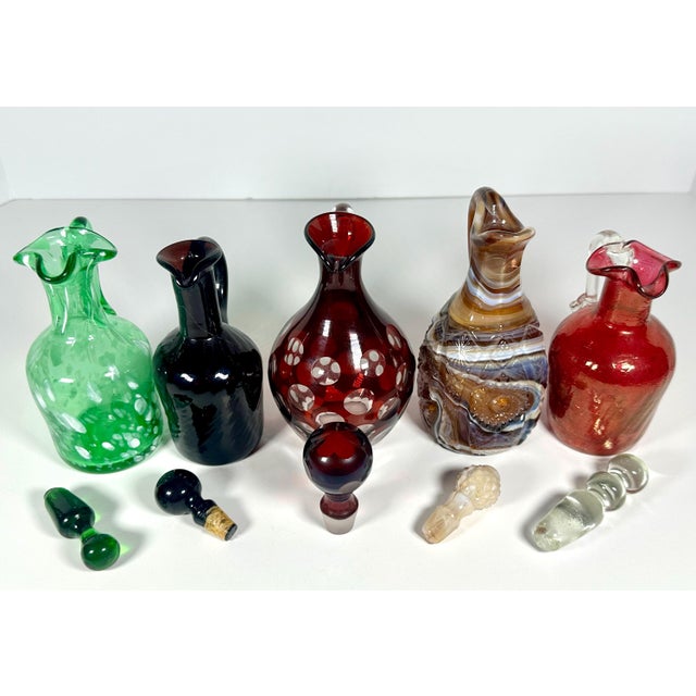 Collection of Five Art Glass Cruets for your consideration. The description of each cruet is as follows: 1. Ruby Red Cut...