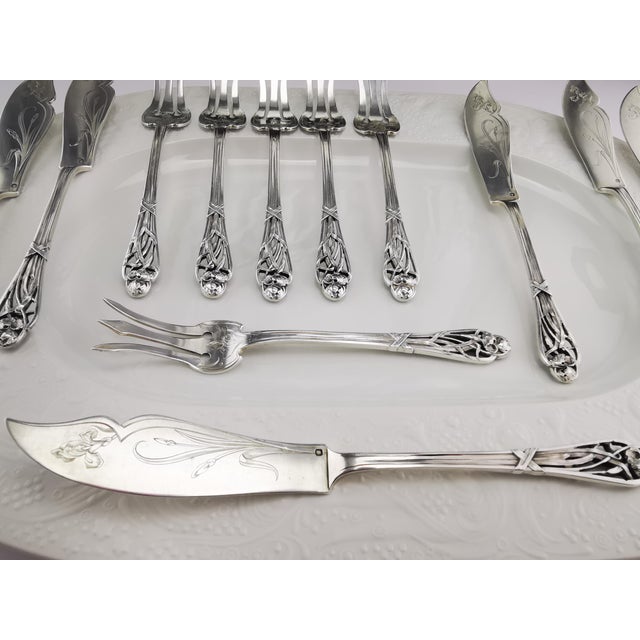 A beautiful set of six fish knives and six fish forks in solid silver (950/1000) from the renowned silversmith Hénin & Cie...