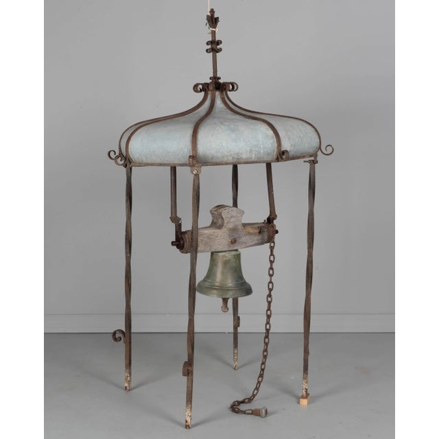 A 19th century French cupola from a rooftop belfry housing a cast bronze bell. Cupola has wrought iron frame with zinc...