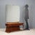 Petineause with double drawer under the top, in mahogany veneer, back-treated glass top, brass profile and details. This...