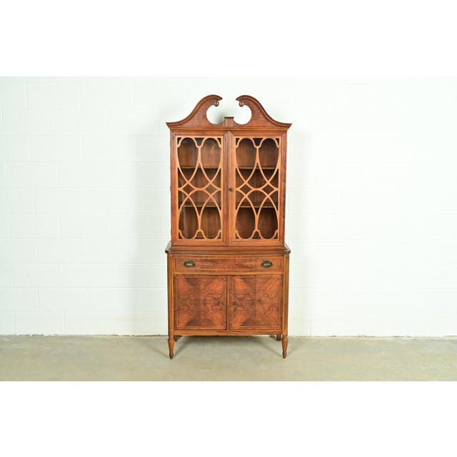 A gorgeous Georgian or Chippendale style breakfront bookcase or dining cabinet In the manner of Baker Furniture USA, Circa...