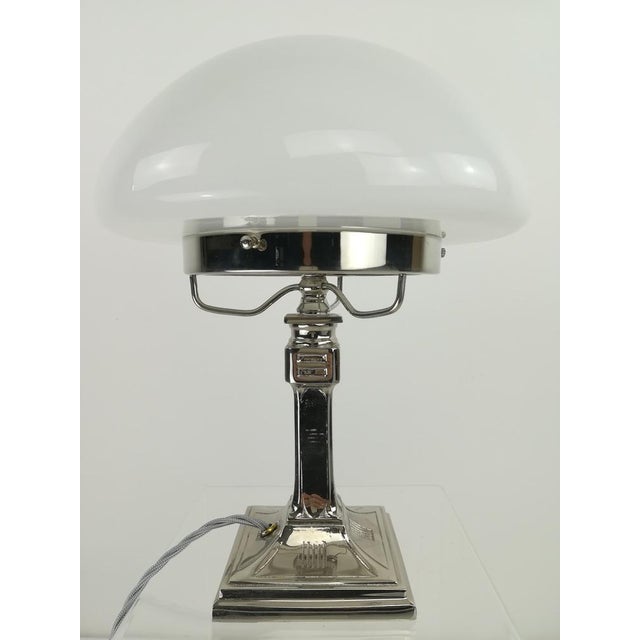 Chrome-plated brass table lamp, massive. Opal overfong glass. The lamp gives a cozy non-dazzling light. Wired according to...