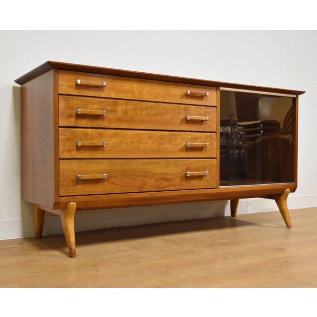 A beautiful cherry and maple credenza designed by Lorenzo Rutili for Johnson Furniture with two glass sliding doors and...