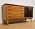 A beautiful cherry and maple credenza designed by Lorenzo Rutili for Johnson Furniture with two glass sliding doors and...