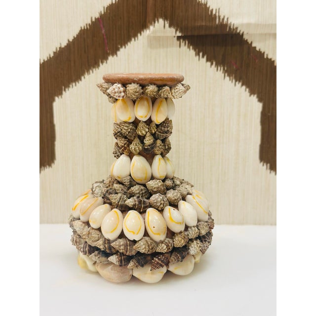 This charming vintage vase has been creatively embellished with an array of natural seashells, giving it a whimsical...