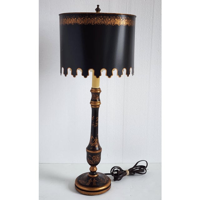 Vintage Chinoiserie style handpainted table lamp with Tole shade by AG Collection. The wooden lamp base is gilted with...