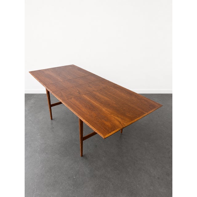 Gorgeous restored vintage 1960s teak and oak wood Scandinavian dining table. Includes two original leafs that expand the...