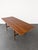 Gorgeous restored vintage 1960s teak and oak wood Scandinavian dining table. Includes two original leafs that expand the...