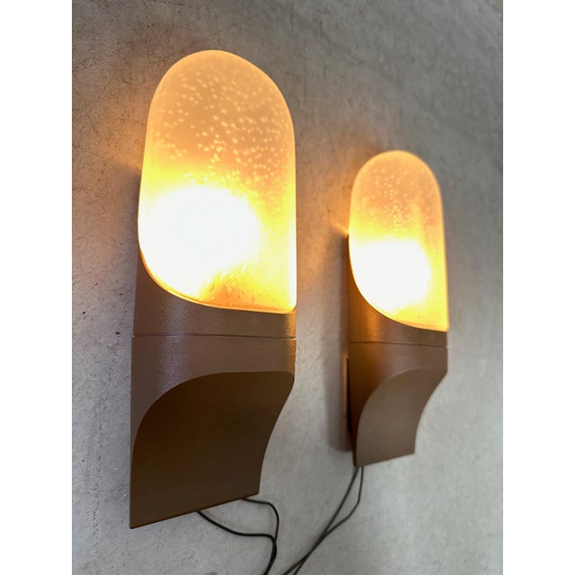 Vintage wall lamps with a minimalist sleek design. Brown plastic holder with frosted glass closed hood. Marked with the hp...