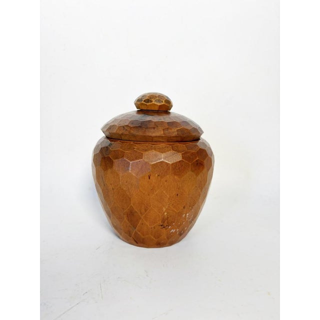 A French tea caddy from the 1970s, crafted from carved wood, featuring remarkable faceting across its entire surface. The...