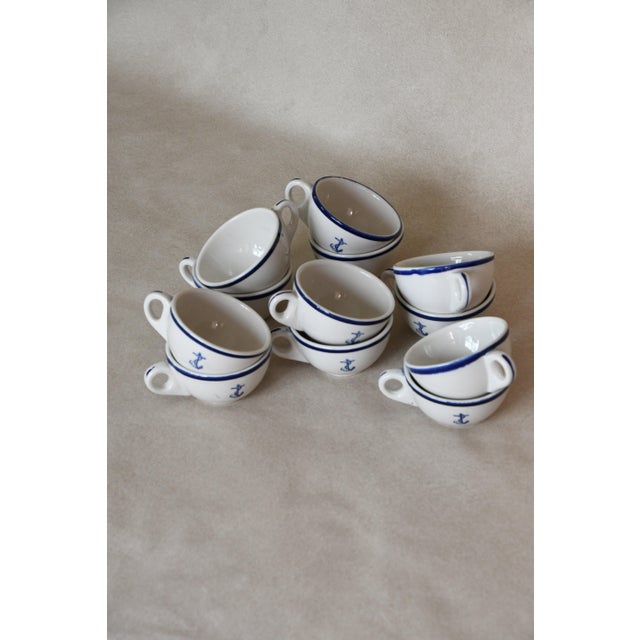 Discontinued Homer Laughlin US Navy mess hall tea cups featuring a cobalt blue anchor motif and stripe detailing. Sold as...