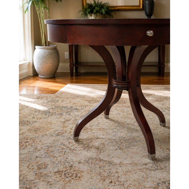 Striking vintage Ethan Allen round pedestal table featuring a dramatic starburst inlaid top and convenient storage drawer....