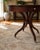 Striking vintage Ethan Allen round pedestal table featuring a dramatic starburst inlaid top and convenient storage drawer....
