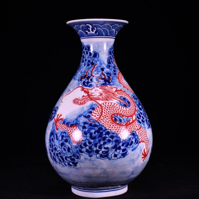 A striking Chinese porcelain vase featuring a classic pear shape (Yuhuchunping). The vase is decorated in vibrant cobalt...