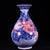 A striking Chinese porcelain vase featuring a classic pear shape (Yuhuchunping). The vase is decorated in vibrant cobalt...
