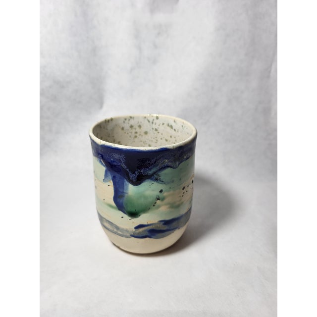 Vintage studio art pottery vase in green, gray and blue. Signed by artist on bottom.