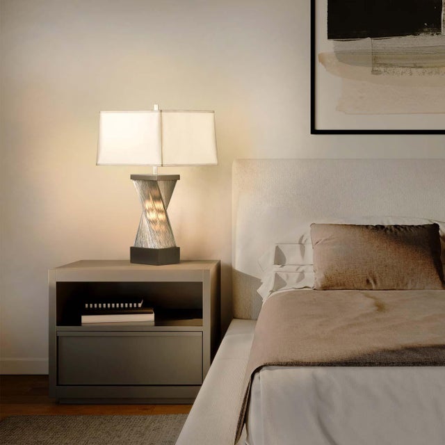 The Accent Torque Table Lamp is an intriguing blend of sculpture and accent lighting, making it an eye-catching addition...