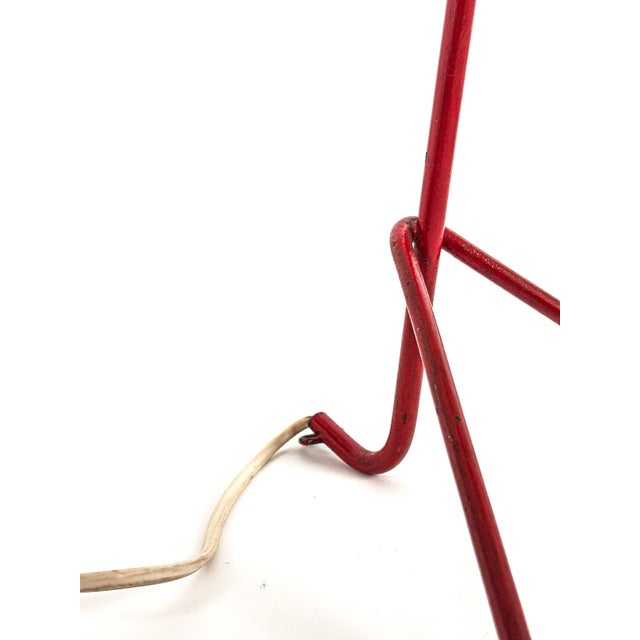 A striking Swedish Modern table lamp from the 1950s, executed in lacquered metal with elegant brass detailing and a...