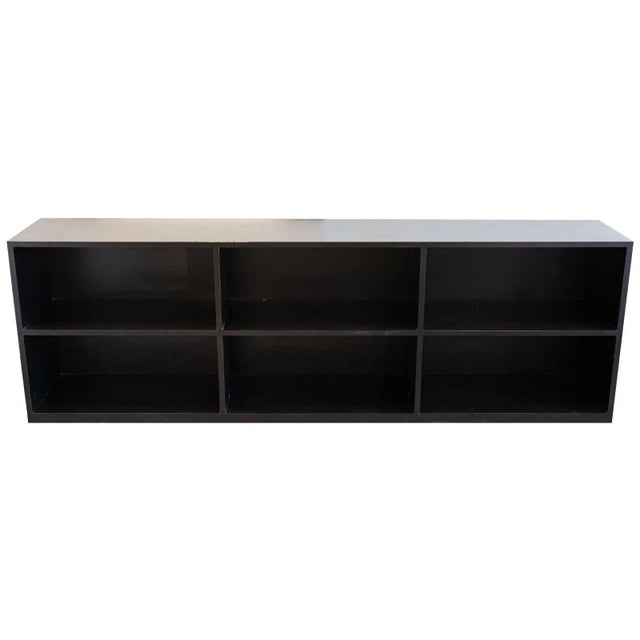 A large black shelving unit. This versatile shelving unit is a great addition to any room. Its very dark black coloring...